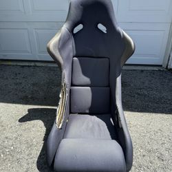 fixed-back (non-reclining) bucket seat with a hard composite shell