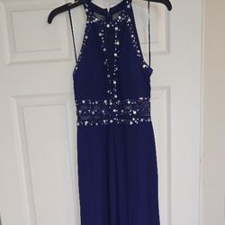 This is a Morgan & Co. navy blue halter-style evening gown with a rhinestone-embellished bodice and 