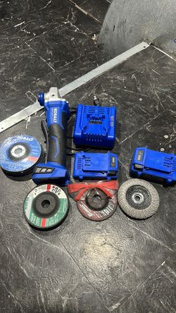 Grinder with 2 batteries a bunch of cutting wheels and safety glasses
