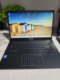 Reliable ASUS VivoBook E410MA laptop in dark blue. This device has an Intel Celeron N4020 CPU at 1.10GHz and 4.00 GB of RAM. It is equipped with a 320