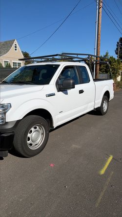 Ford F-150 White Pickup Truck with Ladder Rack