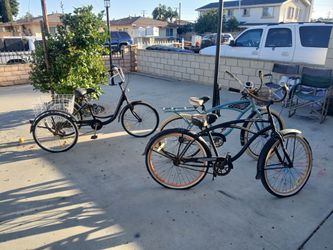 Two men's 26" Beach Cruisers and a three wheel tricycle