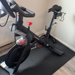 Peloton bike + Clips (x2) & Mat/Pad