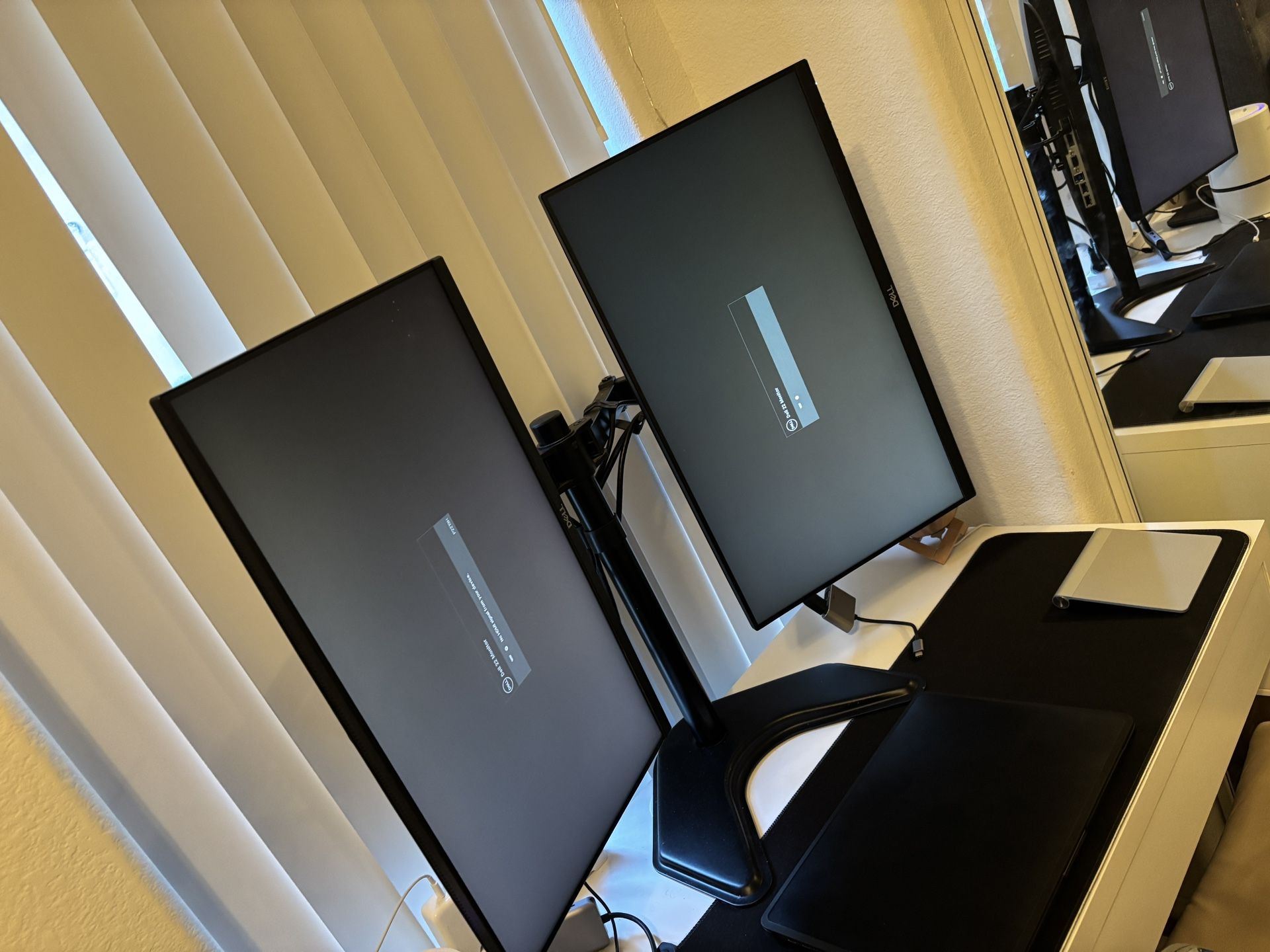 Two 21” Dell monitors with stand