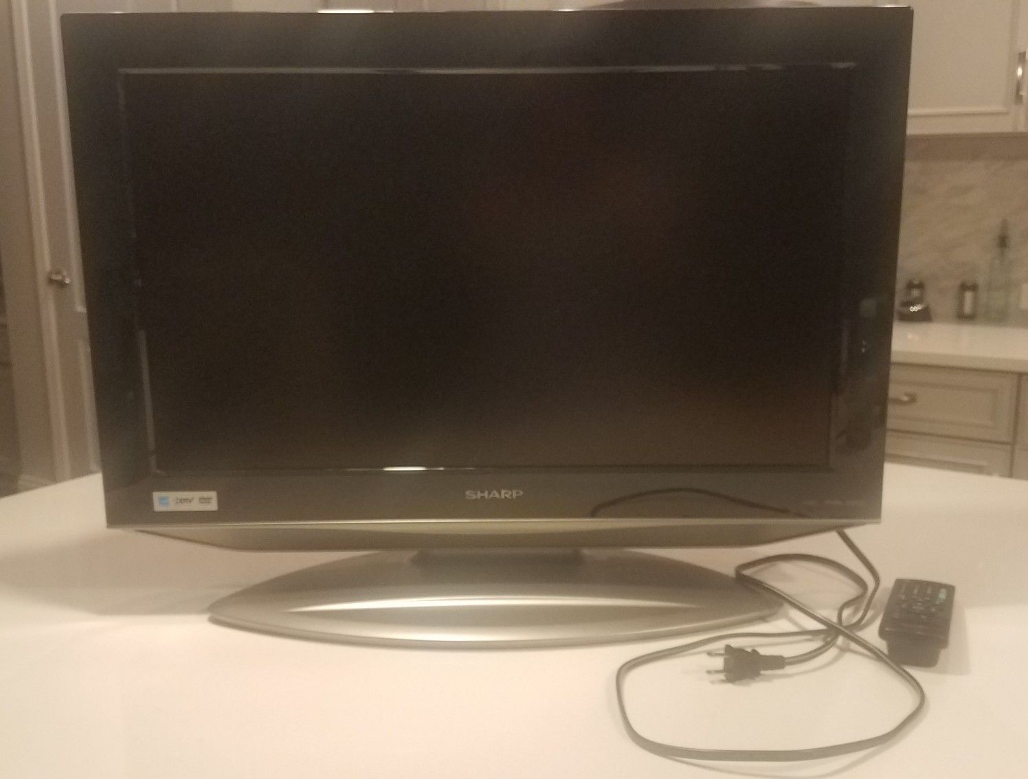 25" Sharp HDTV with built in DVD player, wall mount and remote control