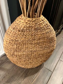 Large rattan  basket with decorative wood stems
