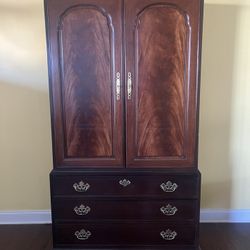 Solid mahogany linen press armoire with intricate carving and flame crotch mahogany front