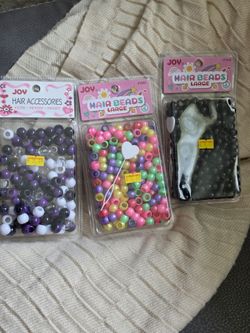 Three, new, packs of hair beads.