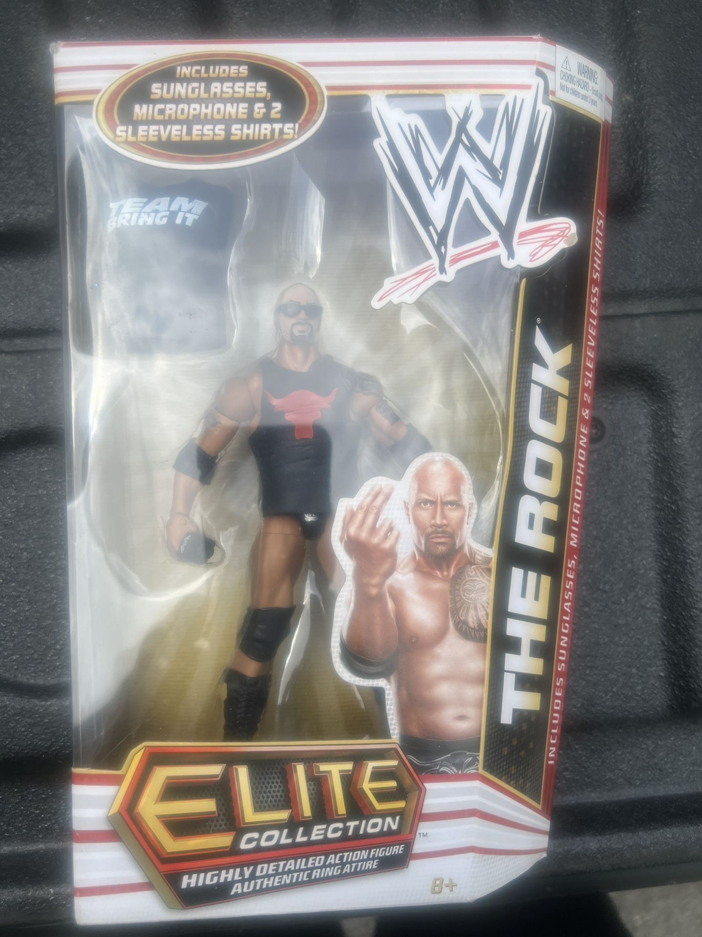 WWE Elite Collection Wrestling action Figure The Rock, series 16, includes Microphone, sunglasses, and 2 sleeveless shirts, new in package
