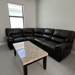 Brown manual recliner sectional sofa and marble table.