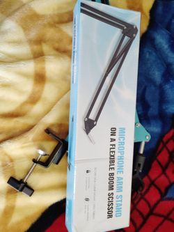 A blue microphone arm stand broom scissors clamp