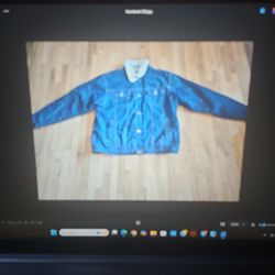 The men's or unisex XL jean jacket is for sale.