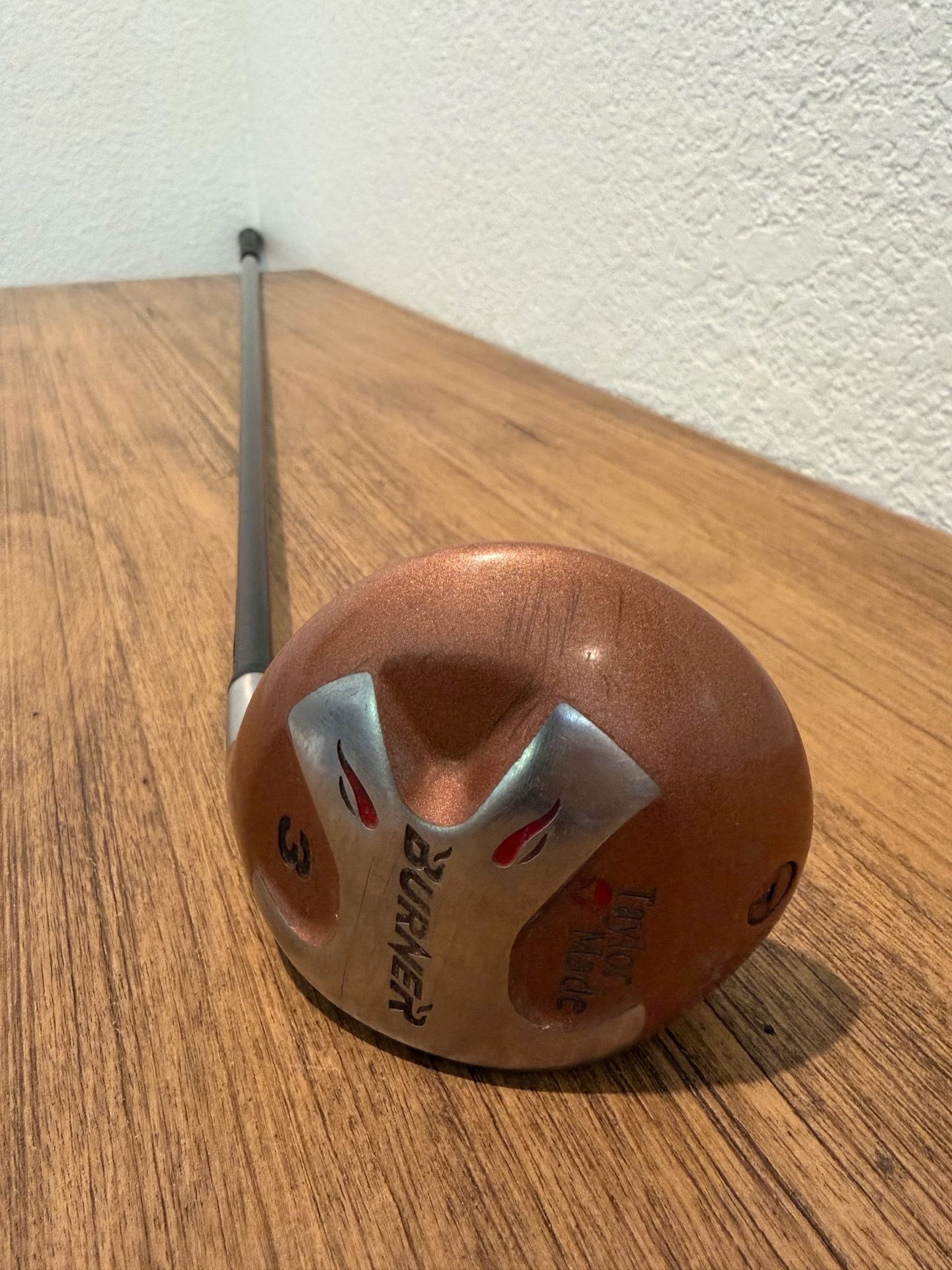 TaylorMade men's driver with a brown and silver head. Forgiving shape for long tee shots. Textured brown finish with silver accents. Slim black shaft