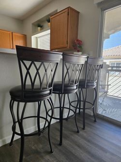 3 - Leather Swivel bar stool (If it's  posted, YES it's available)