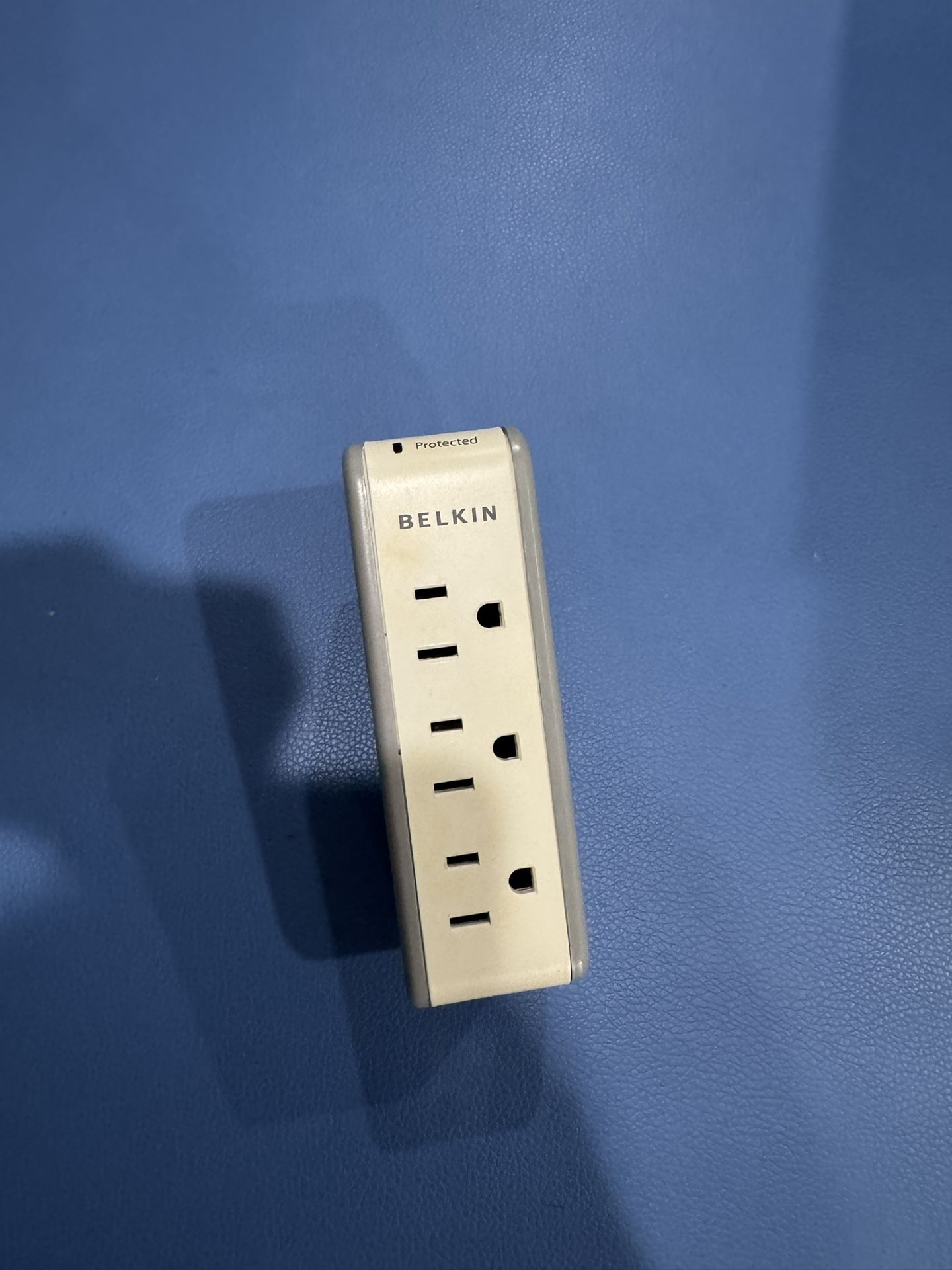 Compact Belkin surge protector with three outlets and two USB ports