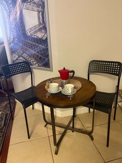 Round Bistro Table with Two Black Chairs