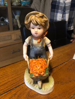 Vintage boy with wheelbarrow figurine