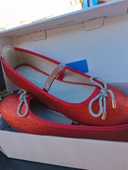Mary Jane style flat with a stretchy rhinestone strap and a front bow.