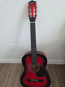 Redand black Crescent acoustic/classical guitar.