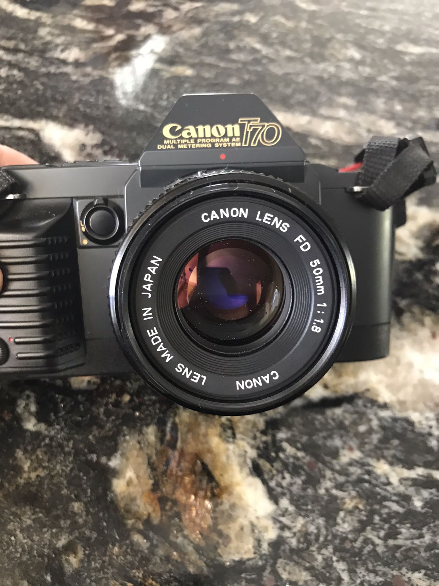 Canon T70: 35 mm camera with flash and lens