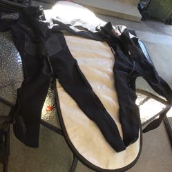 Two Dark Color used ONEILL  Wetsuits , and 1  6’3  Surfboard Cover.  