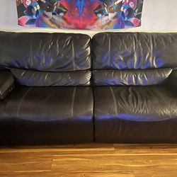 Black Leather Couch.  Both Seats Electric Recliner. 