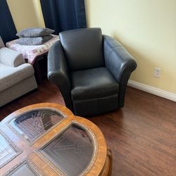 Two Leather Sofa Chairs That Swivels
