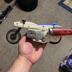 vintage Ideal Evel Knievel Super Jet Cycle from the 1970s.  It is a collectible toy featuring a flywheel-powered mechanism designed to perform jumps a
