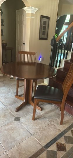 Small wooden table with two padded chairs