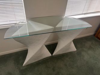 Glass table on pedestal
