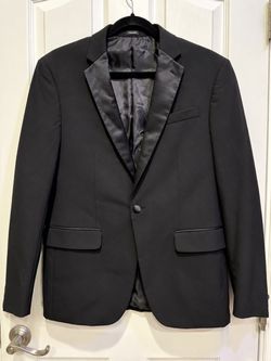 Classic men’s charcoal gray blazer with a subtle fine pinstripe texture and a clean tailored silhouette. Versatile enough for work, weddings, dinners,