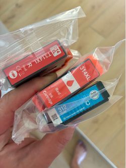 New in plastic Epson ink cartridges (2 red, 1 cyan)