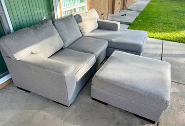 Sectional couch and ottoman from Ashley in good condition.