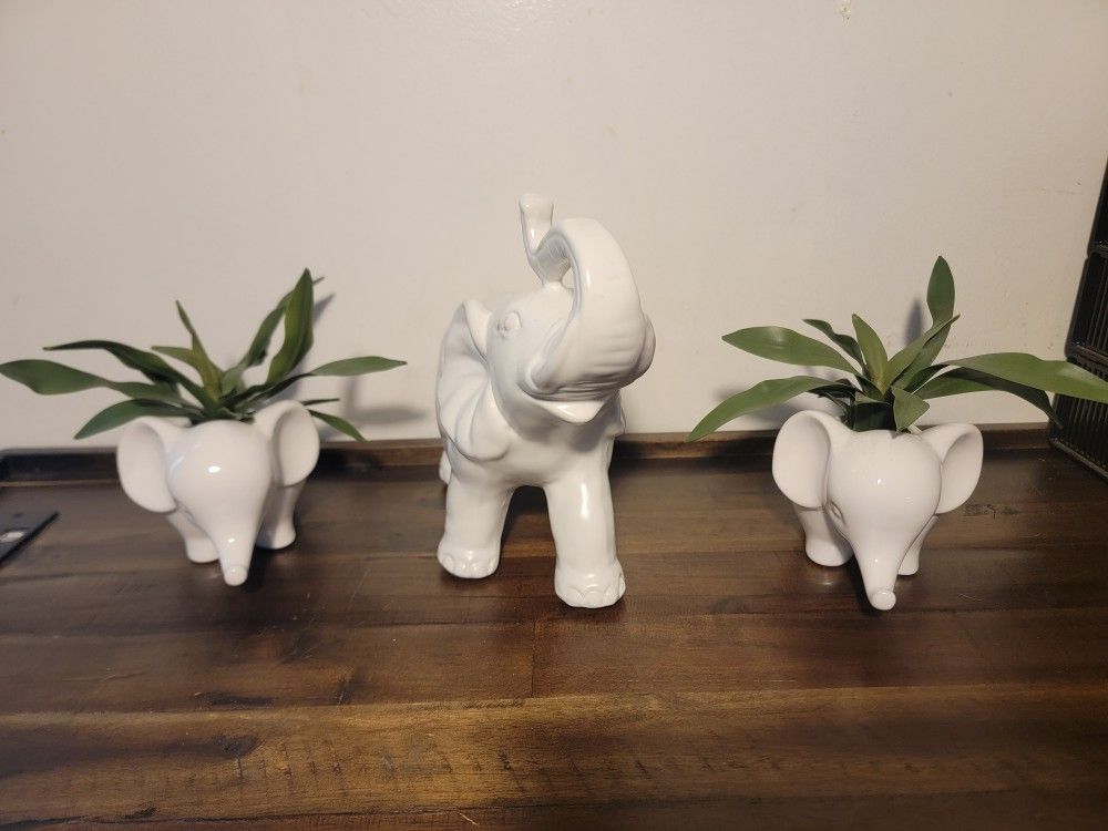 Set of 3 Cute Animal Elephant Shaped Ceramic decorations. 2 small elephants have artificial plants in them.