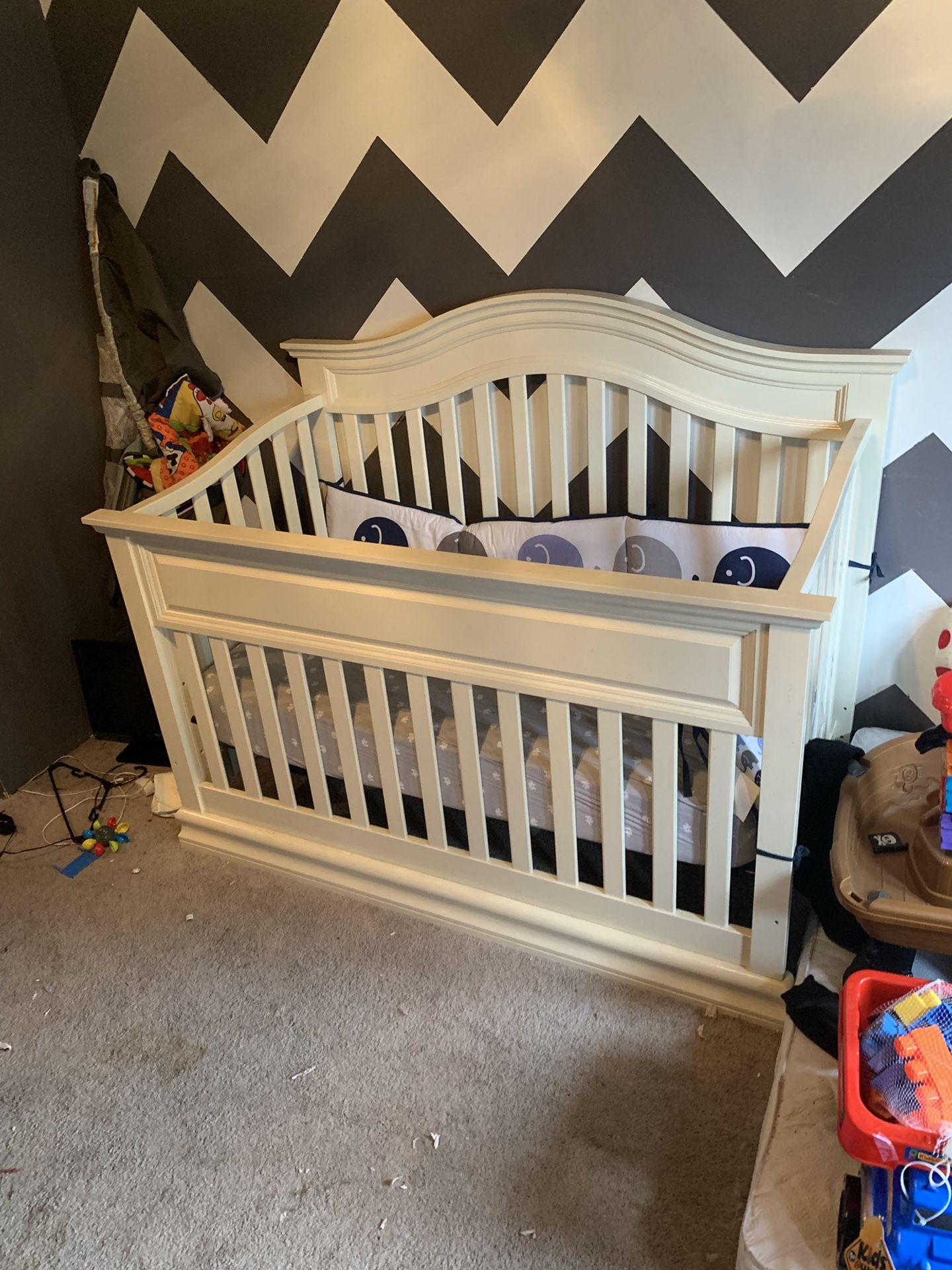 Crib and changing table and dresser.