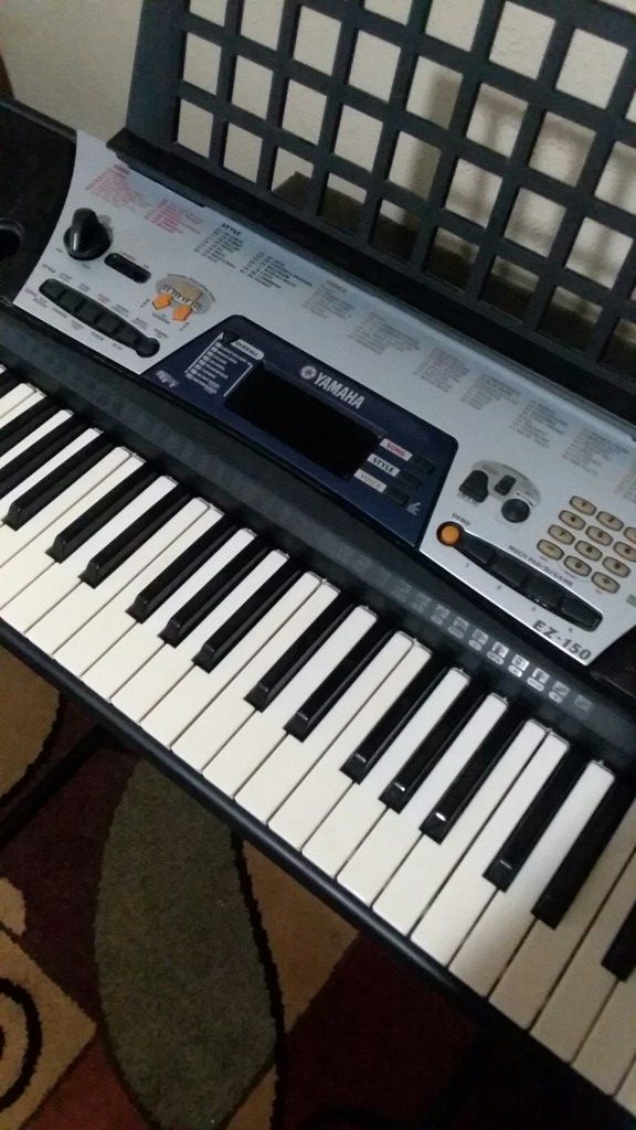 (LIKE NEW) YAMAHA EZ-150 PORTABLE ELECTRONIC KEYBOARD/PIANO/ORGANS WITH STAND AND POWER ADAPTER, ASKING $225