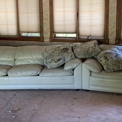 A large three-piece leather couch with queen size bed