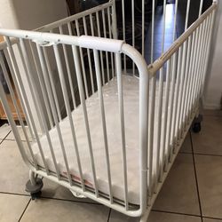 L. A  Metal Folding Baby Crib
