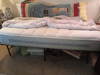 Practically new Twin size mattress, and a metal frame.