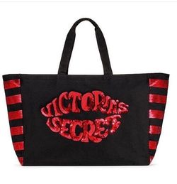 Victoria's Secret Weekender tote bag made of black canvas featuring a distinctive red sequin lips https://offerup.com/redirect/?o=ZGVzaWduLkRlc2lnbg==