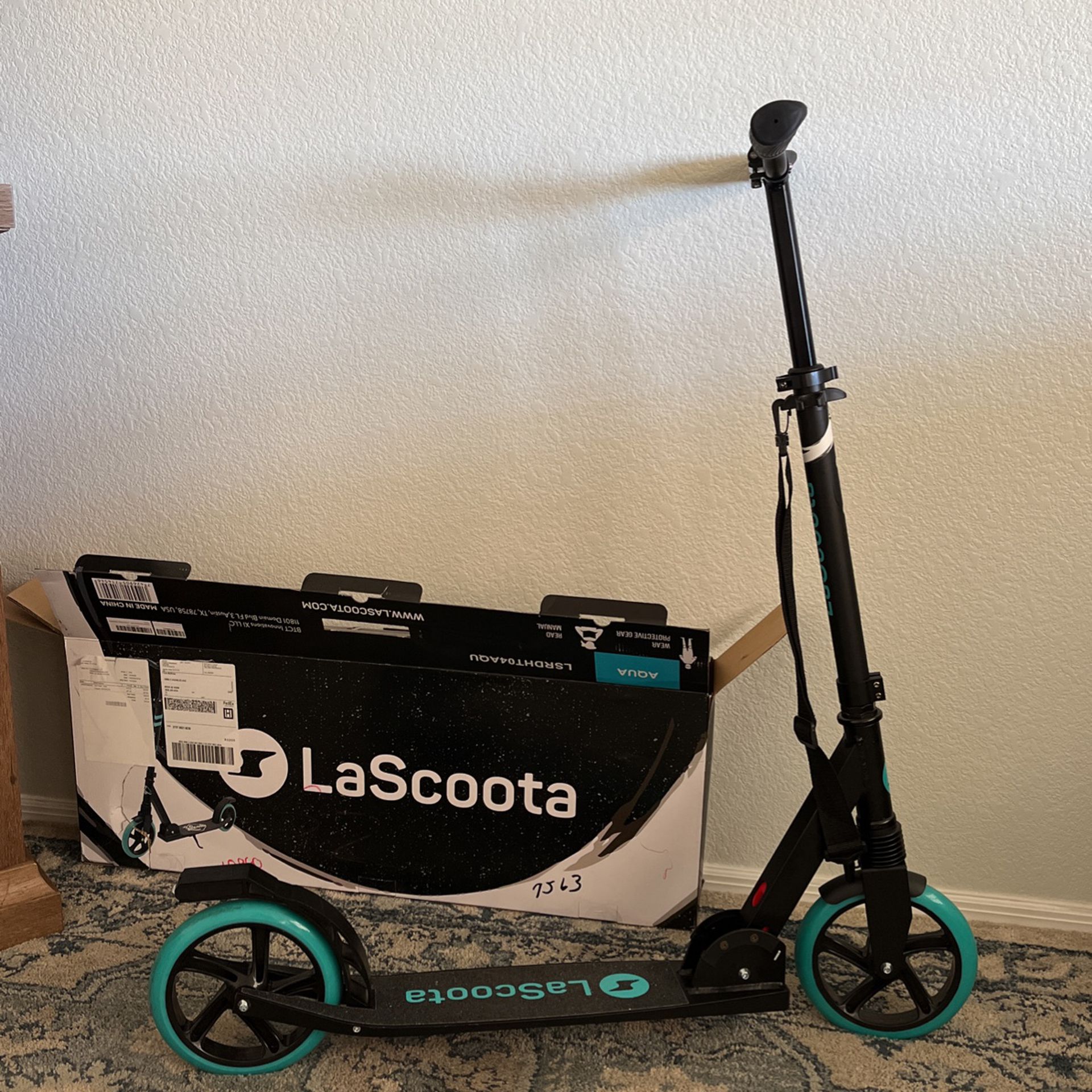 LaScoota Adult Sized Scooter,  Folds With A Carrying Strap. New $50.00..