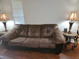Brown microsuede Ashley Furniture couch with feux leather bottom.