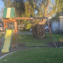 Like new compact swing set with slide table treehouse