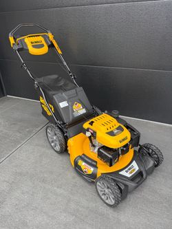 DeWalt RWD self-propelled gas lawn mower in yellow and black. Includes rear bag, side discharge chute, and documentation. All original tags still atta