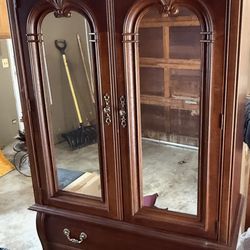 TV cabinet or armoire has bar to hang clothes