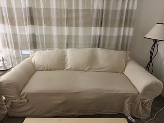 Sofa with Cream Slipcover. Come with extra set sage green slip cover
