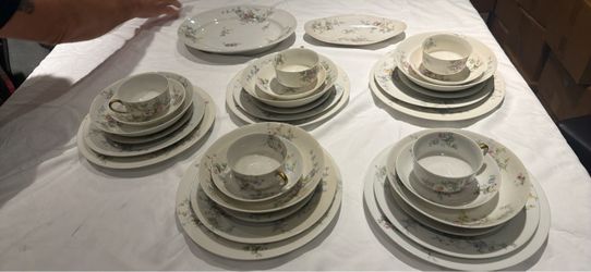 M. Redon Limoges porcelain dinnerware set from France, featuring delicate multicolored flowers and gold-handled teacups.
