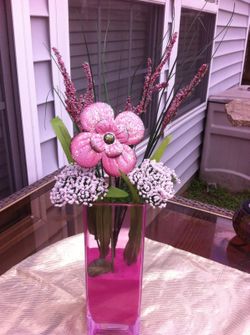 Pink centerpiece with glass and metal flower
