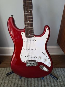 Squier by Fender Stratocaster electeic guitar- candy apple red