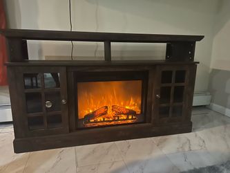 Dark wood TV stand with electric fireplace